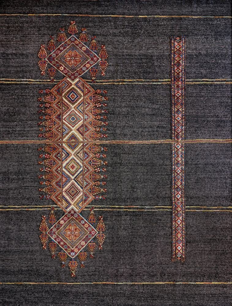 A charcoal handmade rug with a woven medallion column, by Olker Rugs